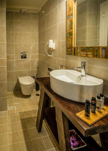 a bathroom with a sink and a toilet at Castelli Cottage in Acharavi