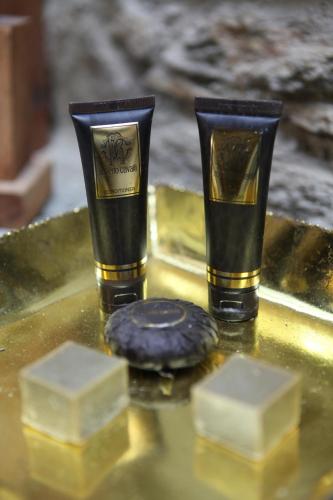 two cups sitting on a gold tray with a cookie at Ibri Hotel in Selcuk