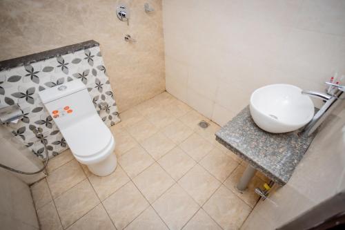 a bathroom with a white toilet and a sink at Hotel AB Inn in Kathmandu