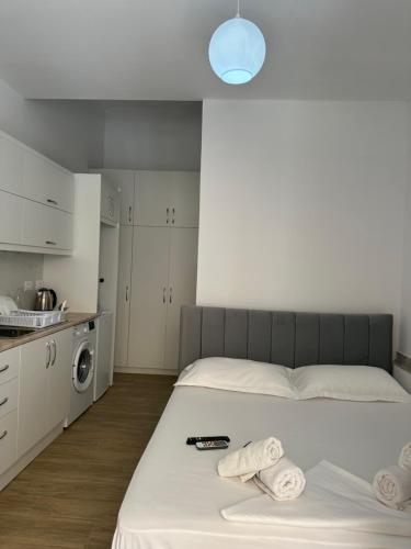 a bedroom with a bed with towels on it at Adela's Saranda Central Apartment in Sarandë