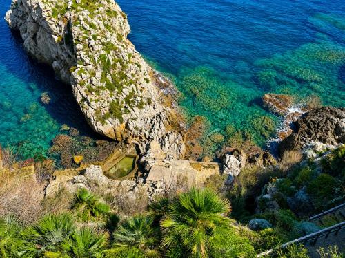 an aerial view of the ocean and a rocky coastline at Villa Cliff in Aspra