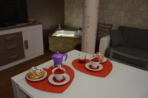 a table with two cups of tea and two plates of food at Casa Aruci Sweet Home in Scicli