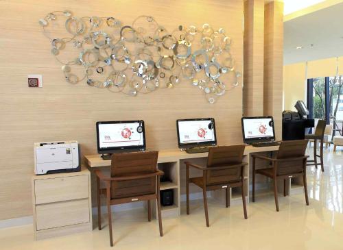 a dining room with a table with four computers on it at Ibis Hua Hin in Hua Hin