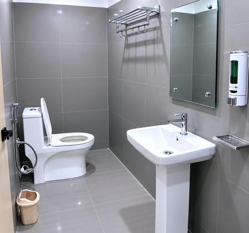 a bathroom with a toilet and a sink and a mirror at Hotel Narsingi in Gundipet