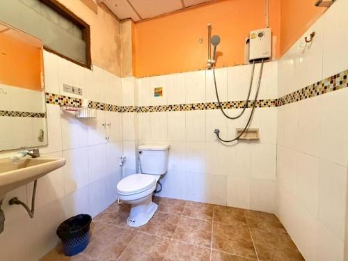 a bathroom with a toilet and a sink at J Home Aonang in Ban Nong Chaeng