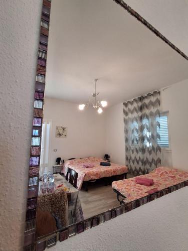 a view of a room with two beds and a mirror at Stella Marys Nord in Olbia