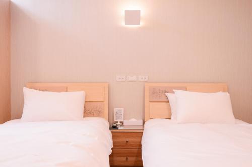 Ένα ή περισσότερα κρεβάτια σε δωμάτιο στο Guest Motel-Zhubei