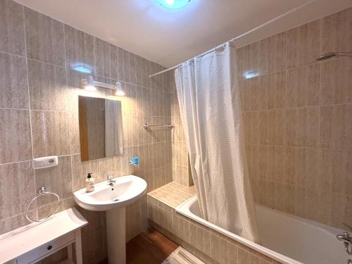 a bathroom with a sink and a toilet and a shower at Los Enebros in Cartaya