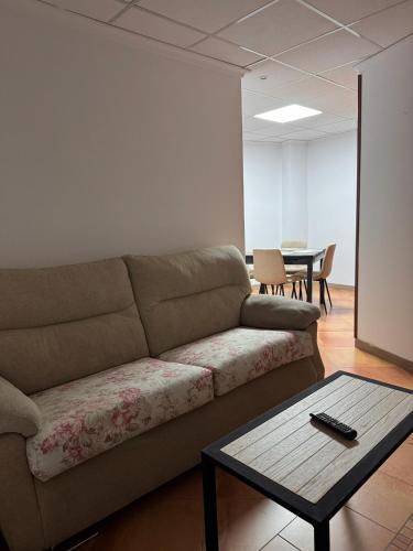 a living room with a couch and a table at Casa Carmen II in Montoro