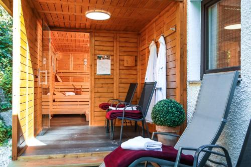 a wooden cabin with chairs and a sauna at AktiVital Hotel in Bad Griesbach