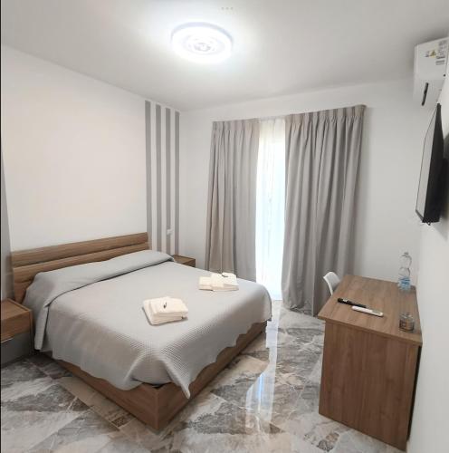 a bedroom with a bed with two towels on it at Dolce Luna in Isola Sacra