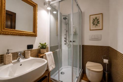 a bathroom with a sink and a shower at Le Dimore della Seta - Palazzo Busdraghi in Lucca