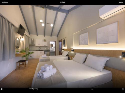 a bedroom with a bed with towels on it at Villa Apollo in Parga