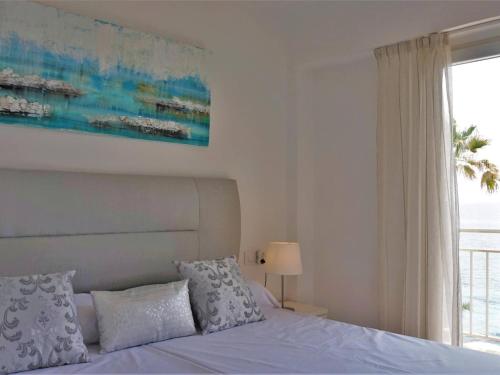 a bedroom with a bed and a large window at La perla del mar 2 in Son Servera
