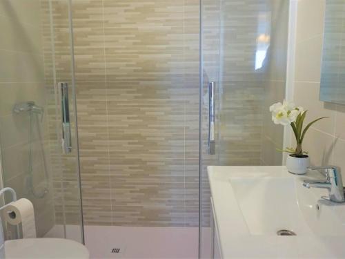 a bathroom with a shower and a sink and a toilet at La perla del mar 2 in Son Servera