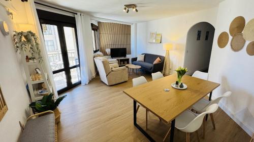 a living room with a dining table and a living room at Calpe Star in Calpe