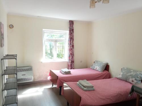 a room with two beds and a window at Special Guest House in Zugdidi