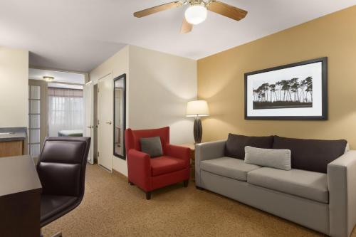 a living room with a couch and a chair at Country Inn & Suites by Radisson, Rochester South, MN in Rochester