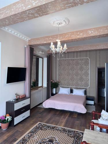 a bedroom with a bed and a television in it at Liders17 in Odesa