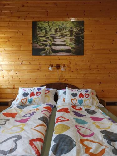 a bedroom with two beds with colorful pillows at Mangó Vendégház in Balatonszárszó