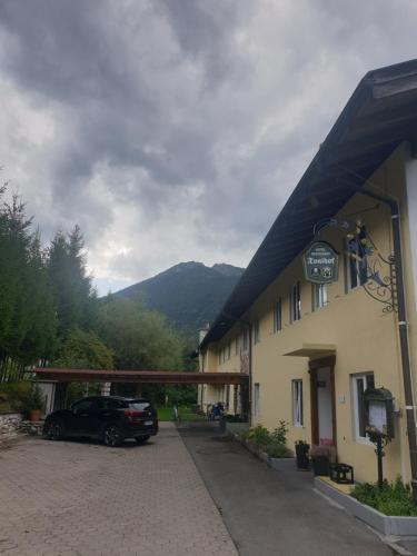 a car parked in front of a building at Hotel Garni Tonihof in Eschenlohe