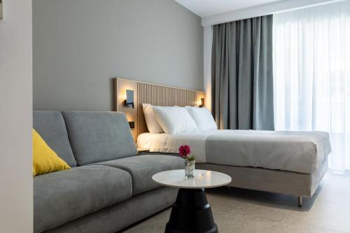 a living room with a couch and a bed at Olympus Jankaea in Paralia Katerinis
