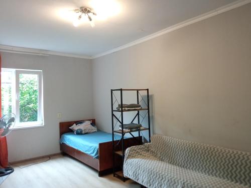 a bedroom with a bed and a shelf at studio with a fireplace in Zugdidi