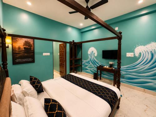 a bedroom with a bed and a painting of waves at Arka by Utkalio in Puri