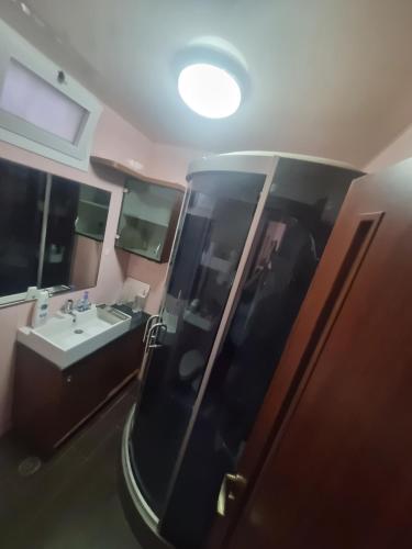 a bathroom with a shower and a sink and a mirror at BlueStay in Qiryat Yam