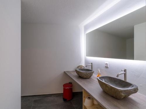 a bathroom with two sinks and a large mirror at Private Rooms near Glarus, Shared Bath in Näfels