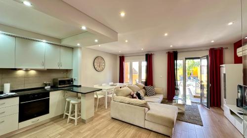 a kitchen and living room with a couch and a table at Alice - Private Pool - 10 Guests - Albufeira in Albufeira