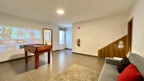 a living room with a foos ball on a table at Alice - Private Pool - 10 Guests - Albufeira in Albufeira