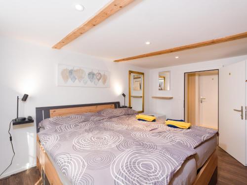 a bedroom with a large bed with two yellow objects on it at Private Rooms near Glarus, Shared Bath in Näfels
