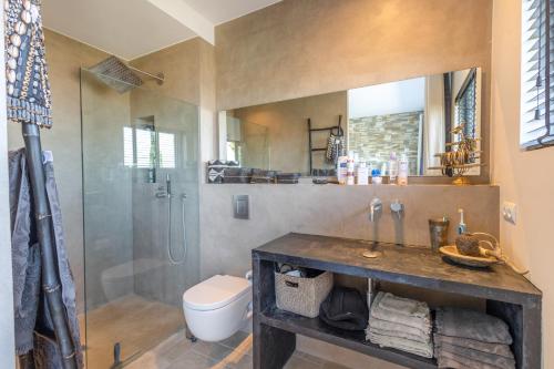 a bathroom with a shower and a sink and a toilet at Sa Punta 99 F2 in Begur