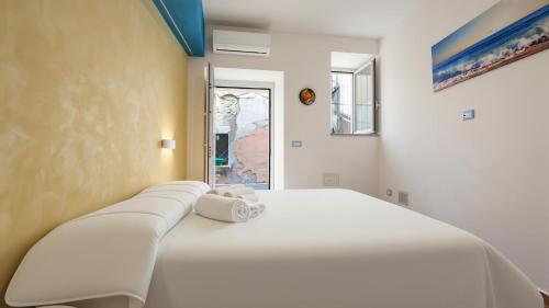 a large white bed with towels on top of it at Rifugio Del Generale - comfort & relax in Pizzo