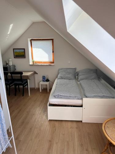 a bedroom with a bed and a table in a attic at Green View Apartment in Wülfrath