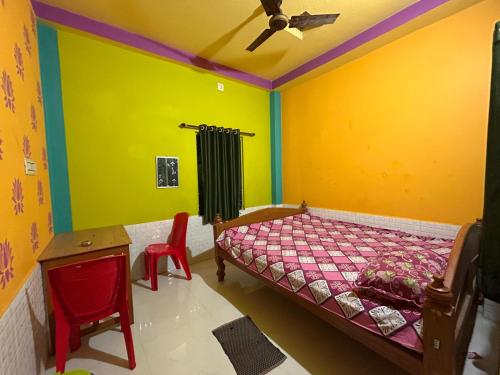 a bedroom with a bed and a table and chairs at Sundarban Residential Hotel in Pātharpratima Island