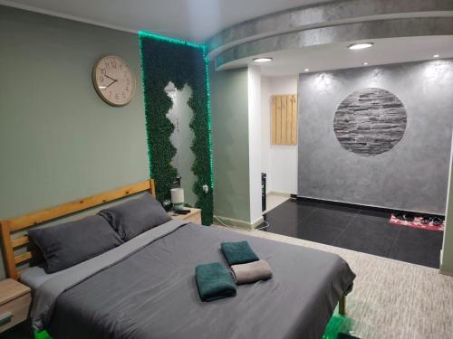 a bedroom with a bed with two pillows on it at DIAstan in Zrenjanin