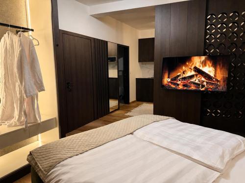 a bedroom with a bed with a fire on the wall at Design-Apartment Siegen Oberstadt in Siegen