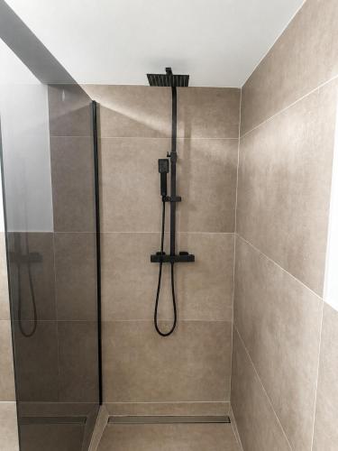 a shower with a shower head in a bathroom at Design-Apartment Siegen Oberstadt in Siegen