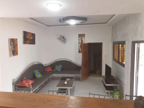 a living room with a couch and a table at Lasofia in Mbodiène