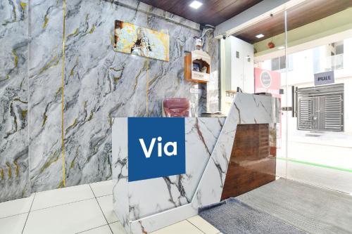 a lobby with a vita sign on a marble wall at Via Mannat in Indore