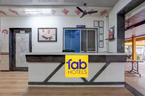 a restaurant counter with a yellow sign on it at FabHotel Raj in Pune