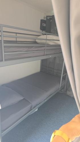 a bunk bed room with two bunk beds in a room at Watercabin in Ooltgensplaat in Ooltgensplaat