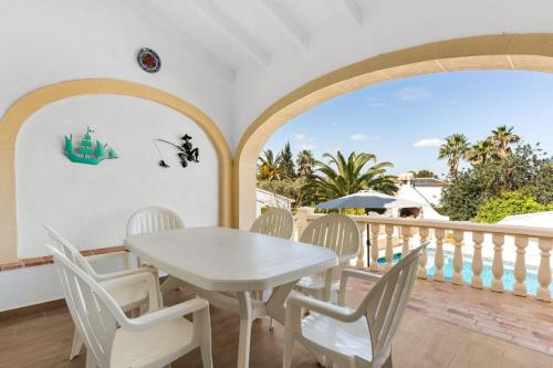 a white table and chairs on a balcony at Villa Casa Para Ti in El Tosalet