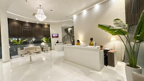 a lobby with two people sitting at a counter at The Theme, Jaipur in Jaipur