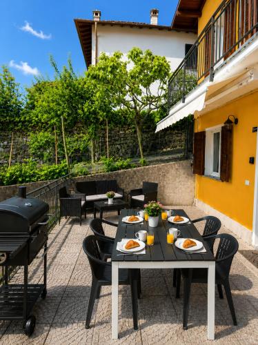 a table with plates of food on a patio at Casa Sophie in Consiglio di Rumo