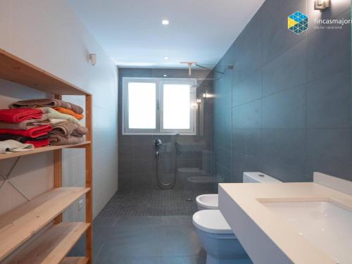 a bathroom with a shower and a toilet and a sink at Villa Sa Troneta in Cala Pi