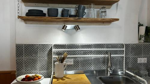 a kitchen with a sink and a bowl of fruit at Danube Atelier - The Studio in Rossatz