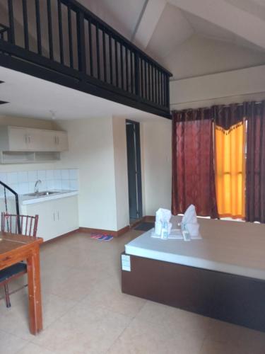 a large room with a kitchen with a bed in it at Central View Apartelle in Angeles